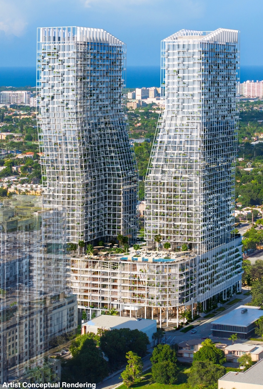 Aerial view of Ombelle Fort Lauderdale's twin towers above Flagler Village with the Atlantic Ocean on the horizon — the Sky Deck amenity breezeway joining the two towers at the 10th floor.
